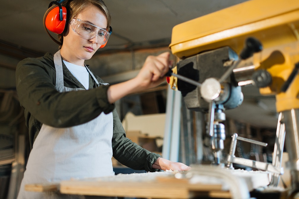 girl crafting furniture of wood